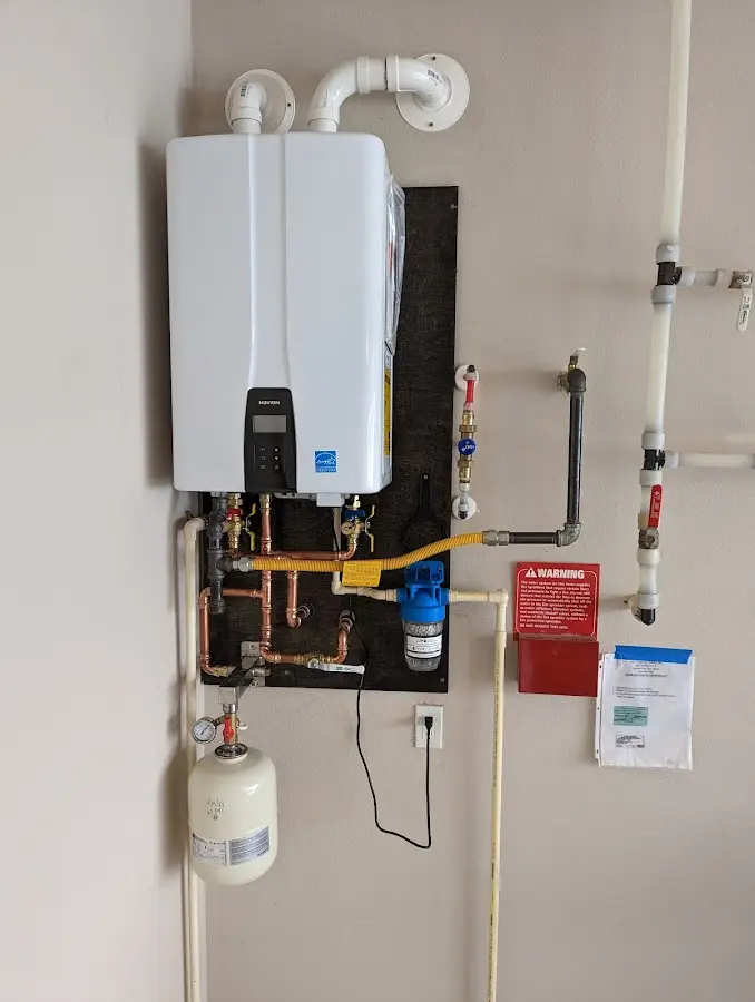 Professional plumber installing copper piping in a Mills River home